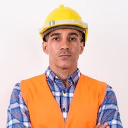 Construction worker in safety gear looking at the camera.